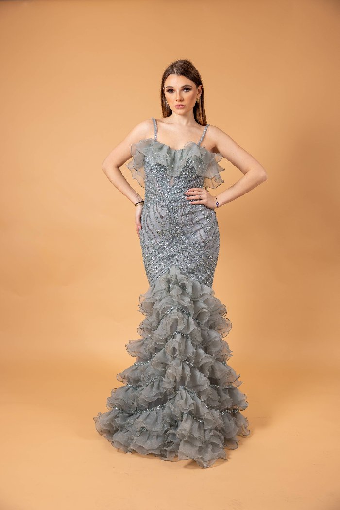 This dress features intricate beadwork and sequins that create an elegant...